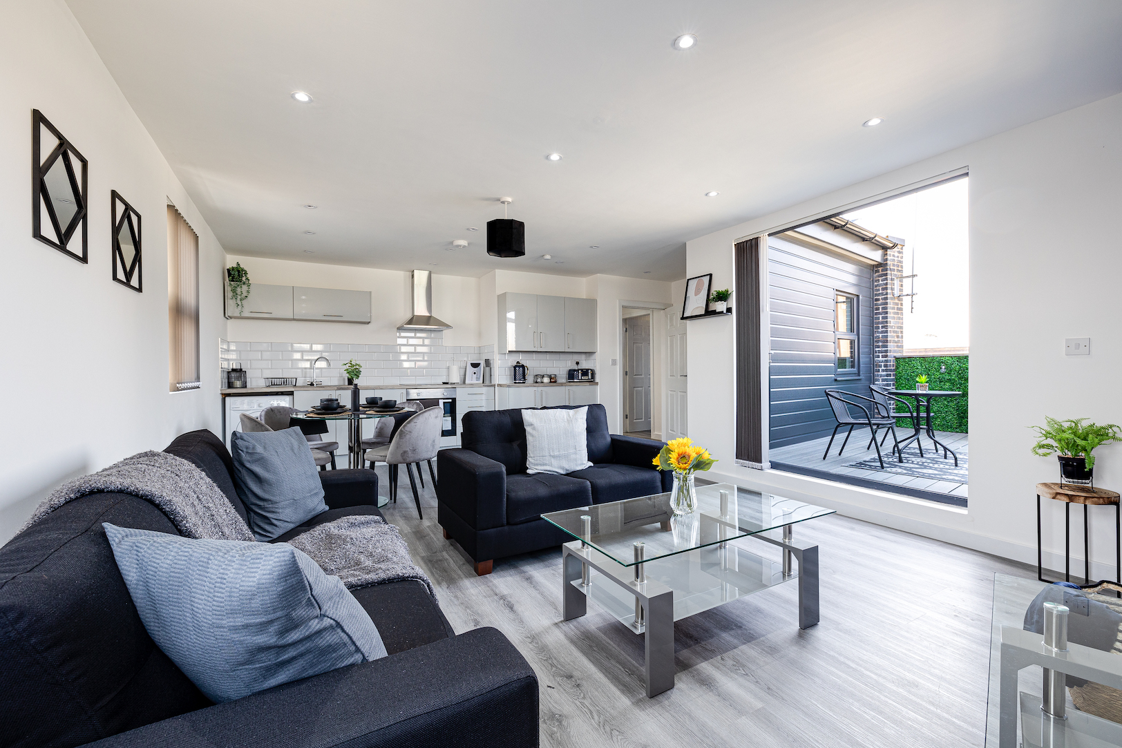 Modern open-plan apartment with stylish living area and outdoor balcony - Manchester co-hosting partnership